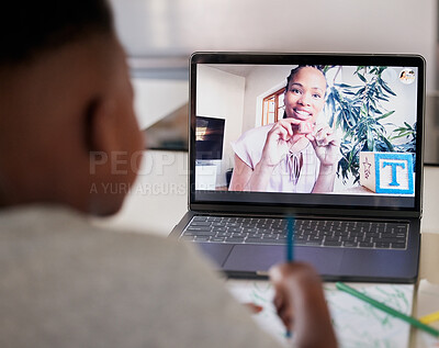 Distance learning with zoom. African american female teacher on a laptop screen home schooling a young boy remotely. Black woman tutor giving a lesson over the internet using wireless technology