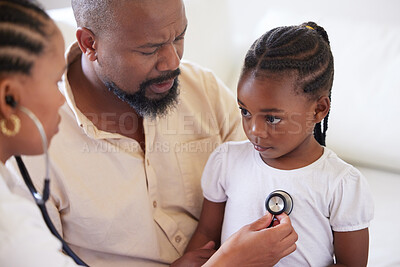 African american female paediatrician examining sick girl with stethoscope during visit with dad. Doctor checking heart and lungs during checkup in hospital. Sick or sad girl receiving medical care