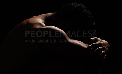 Nude man posing while isolated against black background in a studio. Strong and muscular unknown athlete showing back and naked body in creative, artistic studio. Sexy hot model feeling sensual, free