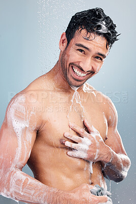 Buy stock photo Portrait of man lathering his body. Young smiling man applying soap to his body in the shower. Hispanic man cleaning his body. Man rubbing soap foam on his body. Multiracial man bodycare, skincare routine