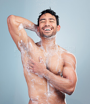 Naked man enjoying a shower in a studio.Man cleaning his body with soap. Young man\'s bodycare routine in a studio.Multiracial man washing his body. Young man hygiene, skincare routine.