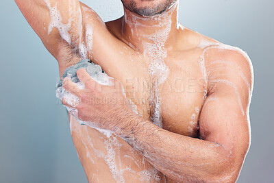 Buy stock photo Multiracial man washing his body. Man rubbing soap on his body in the shower. Man scrubbing his skin and underarms with a loofah in the shower. Closeup hispanic male model bodycare routine