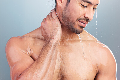 Buy stock photo Mixed race man rubbing his neck in pain while taking shower. Young man washing his body. Man standing under running water in the shower. Practising good hygiene and nursing an injury in the bathroom