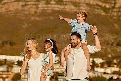 Buy stock photo Carefree caucasian family walking and having fun together outside in summer. Parents carrying their daughter and son on holiday. Little siblings relaxing with their parents on vacation

