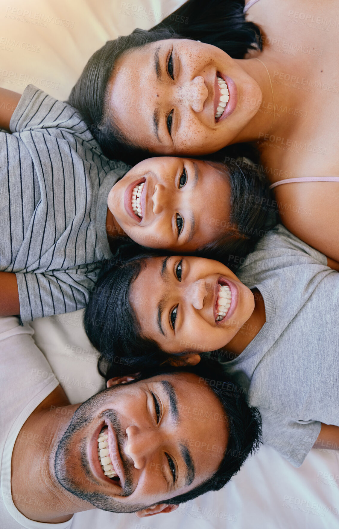 Buy stock photo Portrait, smile and above asian family in bed, relax and having fun while bonding in their home. Top view, love and face of children with parents in bedroom, happy and resting together on the weekend