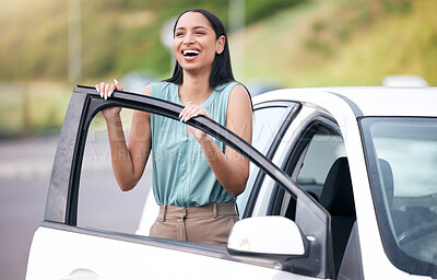 Cheerful mixed race woman driving her new car. Hispanic woman looking happy buying her first car or passing her drivers test. Hispanic woman relaxed about car insurance against bright copyspace