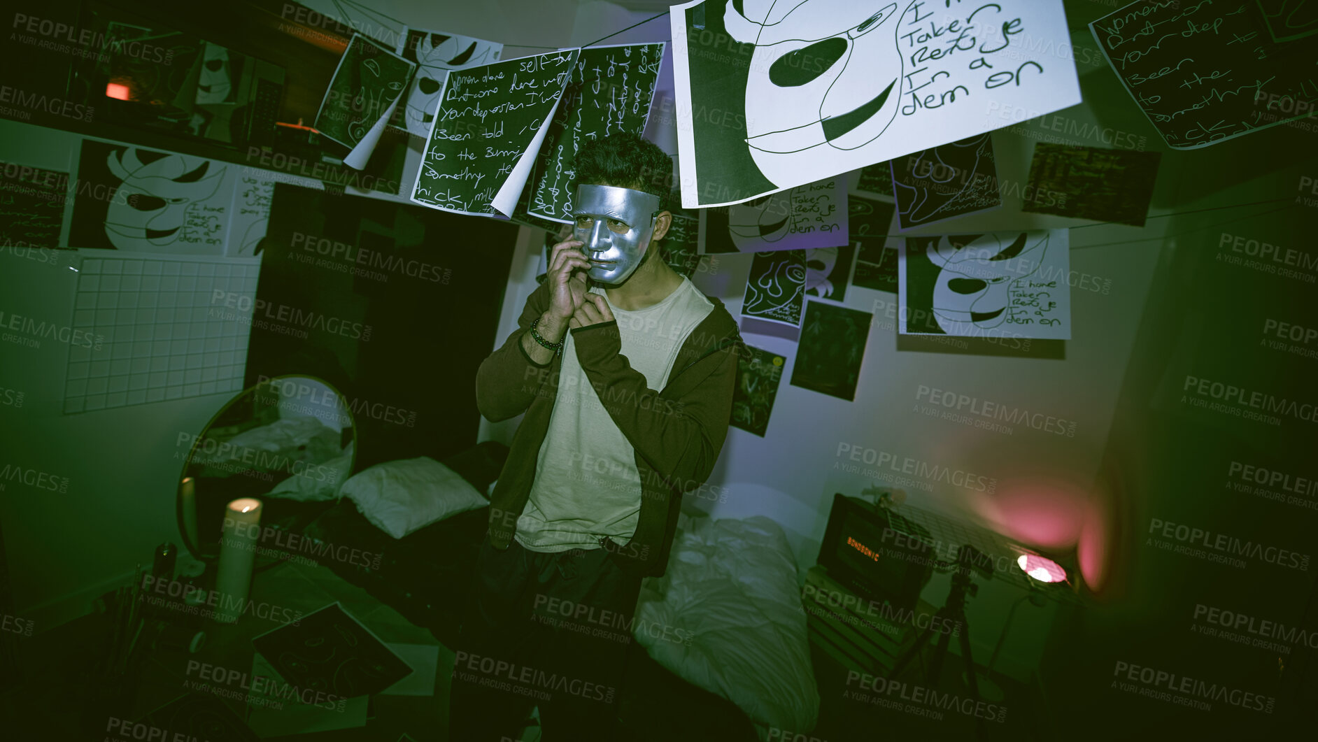 Buy stock photo Unknown masked man with mental disorder sitting alone at night feeling paranoid. Hidden man mentally ill, depressed and holding a mask in his bedroom. Artist having a panic attack with copyspace