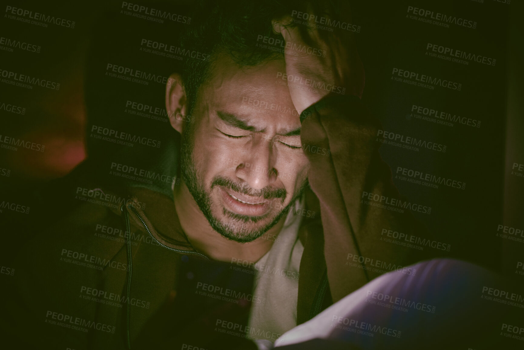 Buy stock photo Asian man with mental disorder sitting alone late at night and feeling paranoid. Mixed race man mentally ill, feeling depressed and crying in his bedroom at home. Insomniac feeling scared and hopeless