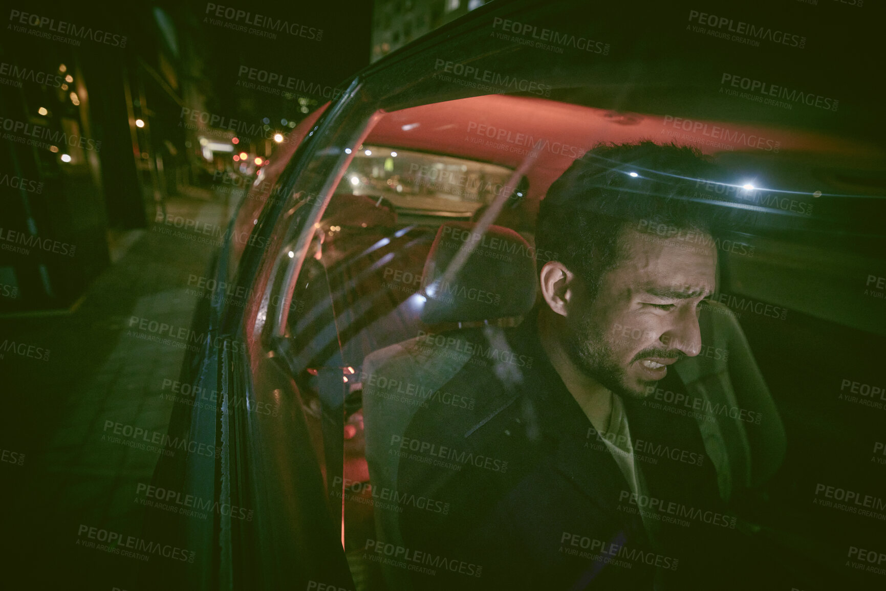 Buy stock photo Asian man with mental disorder looking paranoid and afraid while driving alone in a car at night. Mixed race male mentally ill, depressed and trying to escape a panic attack against urban copyspace 
