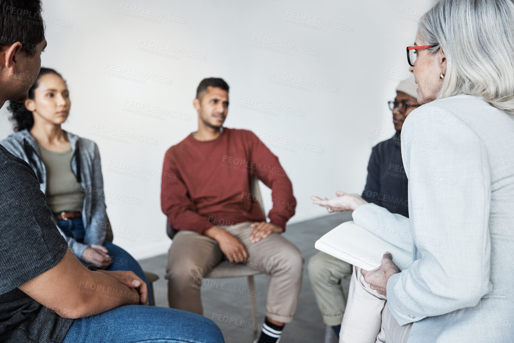 Buy stock photo Counselling, psychologist and group of patients at a therapy session for mental health or depression. Community, diversity and people or friends in a circle talking to therapist at psychology center.