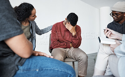 Man having a breakdown during group therapy session about addiction. Counsellor giving support to depressed crying african man at group psychological treatment