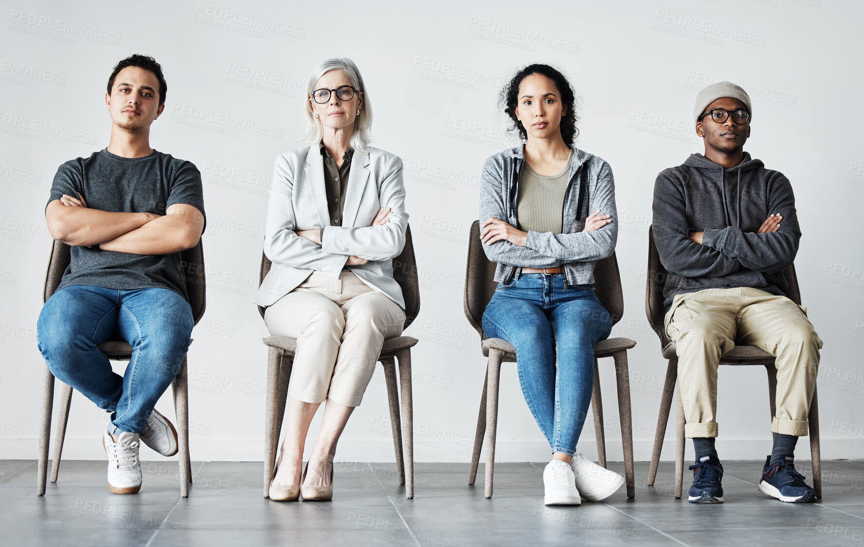 Buy stock photo Businesspeople waiting in line for an interview. Patients sitting in line at doctor's office. Therapist sitting with patients in a row. Portrait of diverse businesspeople with arms crossed.  