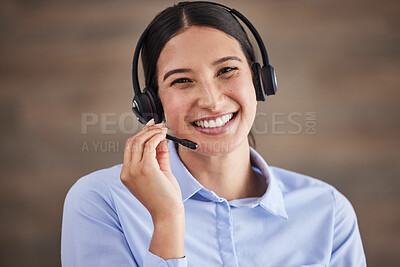Face of businesswoman working in a call center. Customer service operator wearing a headset. Portrait of happy service rep. IT customer service rep. Smiling customer service agent on a call