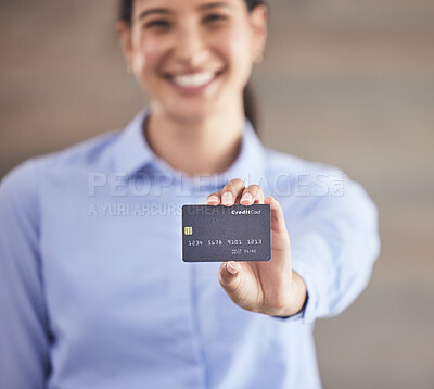 Businesswoman holding credit card. Smiling businesswoman shopping online with a debit card. Happy woman using card to pay bills. Portrait of businesswoman holding a bank card.