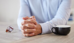 Closeup shot of a man's hands, symbolising worry, stress, anxiety, abuse, mental health, loss, AA, stress, depression, gbv, addiction, fear, phobia, breakup and negative habit while siting at a table 