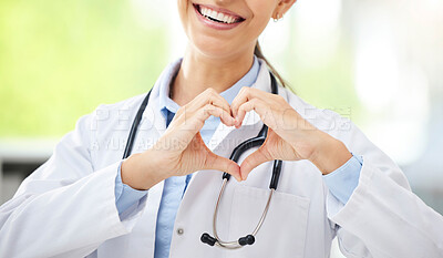 Buy stock photo Love, woman doctor with heart sign and with smile at a hospital for healthcare. Medication or health wellness, nurse and support hand emoji with a female surgeon with stethoscope at a clinic.