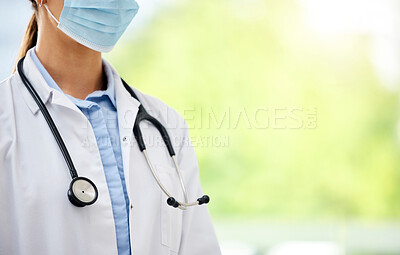 Buy stock photo Closeup of a unknown mixed race female doctor wearing a mask and stethoscope while standing in a office in a hospital