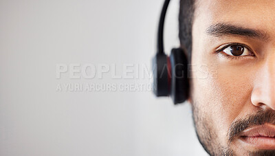 Closeup face of young man listening to music. Portrait of man listening to music through headphones. Multiethnic man listening to music using headphones. Copyspace half face man listening to music