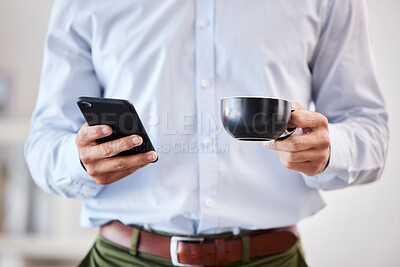 Buy stock photo Closeup of male hands holding coffee and smartphone. Businessman using mobile phone to send text, browse social media or use app while on his tea break 