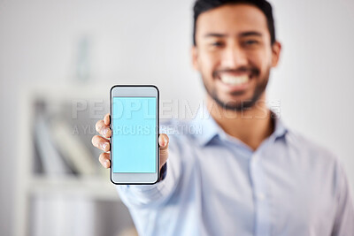 Buy stock photo Businessman showing a blank blue screen with copyspace on his cellphone in the office. Mixed race professional holding his phone to display a new webpage and website. Corporate man using technology