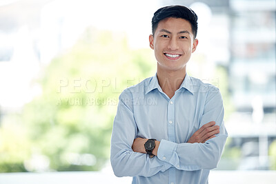 Portrait of confident asian business man standing with his arms crossed. Happy successful male leader and entrepreneur standing in his office. Copy space