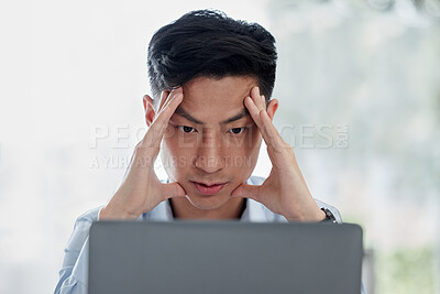 Buy stock photo Stressed asian businessman working on laptop. Frustrated  professional trying to think while working online. Anxious man searching for solution while suffering from a bad headache