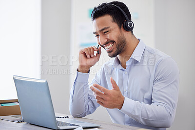 A happy man working in a call center. Operator using a laptop and headset, consulting online or making a video call. A male customer support agent or virtual assistant meeting over video conference