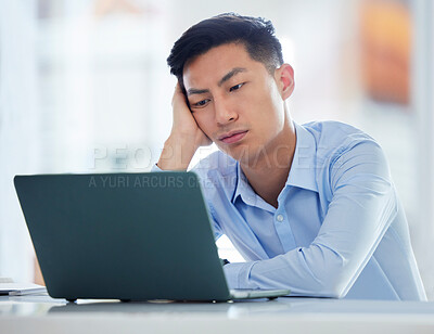 One young asian business man looking bored, tired and demotivated while waiting on slow laptop connection error. Lazy man slacking and ignoring deadlines. Feeling burnout and stress in the workplace