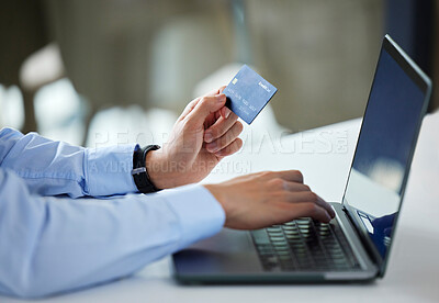 Closeup of one businessman spending money online with a credit card and laptop in an office. Making purchase transaction with secure banking payment. Budgeting finance for bills and ecommerce shopping