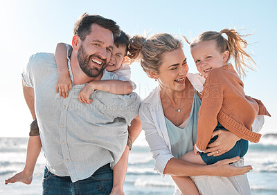 Buy stock photo Happy family having fun at the beach. Portrait of smiling parents with children playing and laughing during a summer holiday. Big toothy smiles showing good dental hygiene and health
