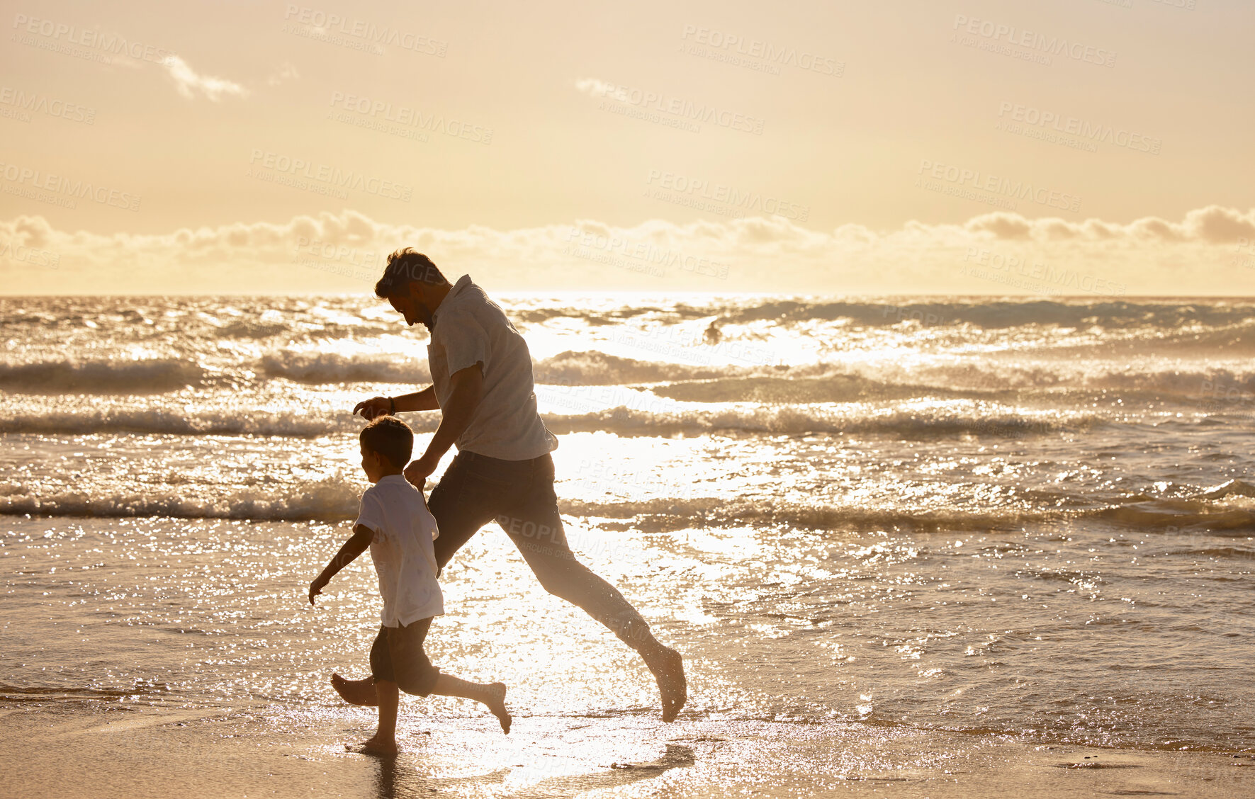 Buy stock photo Single dad playing with son on the beach during the day. Caucasian single father bonding with his son and exercising at sunset. Cute little boy enjoying free time with his parent 