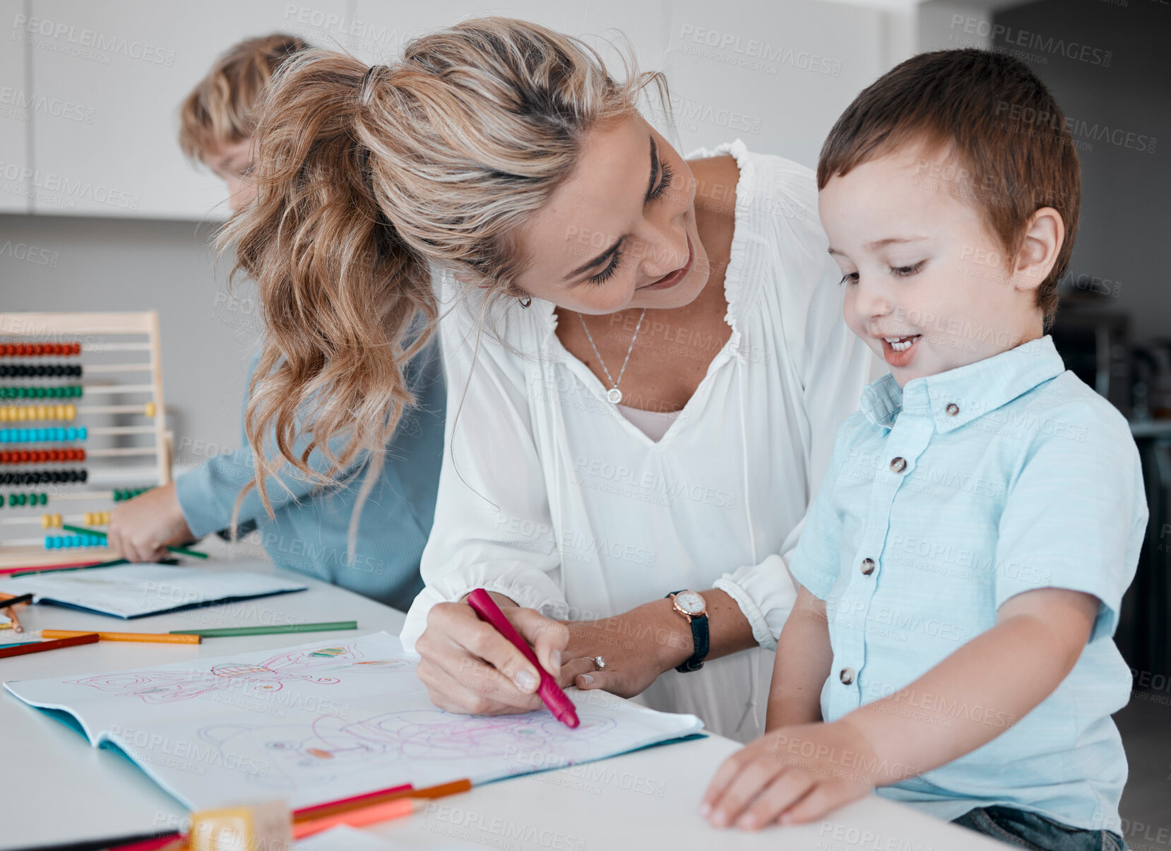 Buy stock photo Family learning together at home. Mother helping son with homework during quarantine. Little boy drawing and having fun getting a distance education.