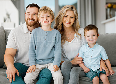 Buy stock photo Portrait of a happy caucasian family looking relaxed while bonding on a sofa together. Adorable little boys chilling on a couch with their loving parents while smiling and looking positive