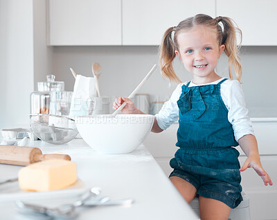 Buy stock photo Happy little girl baking alone. Caucasian child baking in her kitchen. Portrait of a young girl mixing a bowl of batter. Little girl enjoying baking at home. Smiling child baking.