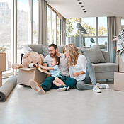 Happy family in a new home. Parents sitting on the floor with child ...