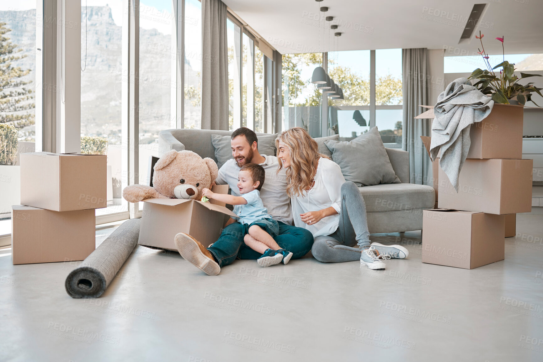 Buy stock photo Moving, box and teddy bear with family in new house for property, investment or future. Real estate, happy and renting with parents and baby in living room of home for relocation, homeowner and relax