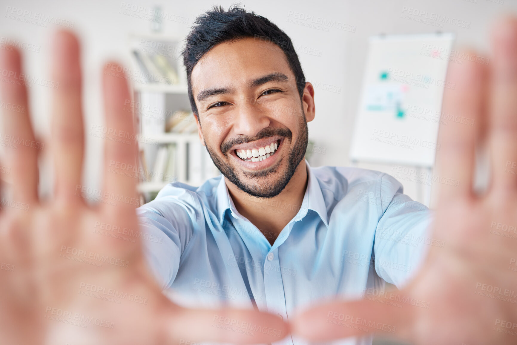 Buy stock photo Portrait of a mixed race hispanic businessman making a frame shape gesture with his hands while smiling in a office. Cheerful hispanic male looking happy