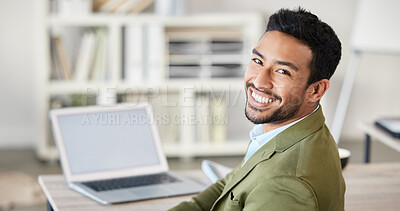 Buy stock photo Portrait of one confident young mixed race businessman working on laptop at desk in an office. Ambitious motivated entrepreneur and leader dedicated to success with hard work. Boss working in startup