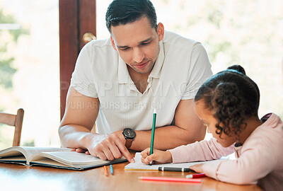 Buy stock photo Mixed race father helping his daughter with her homework. Dad teaching daughter to read and write during homeschool class. Little girl sitting at home with tutor