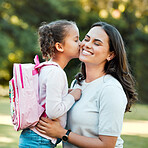Adorable little girl kissing her mother on the cheek outside. Cute mixed race child saying goodbye to parent outside before going into school. Beautiful woman showing love and affection from daughter
