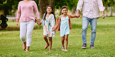 Buy stock photo Family, park and children holding hands with parents  walking, bonding and time in nature together with smile. Mother, father and kids walk on grass field for fun outdoor adventure in garden or woods