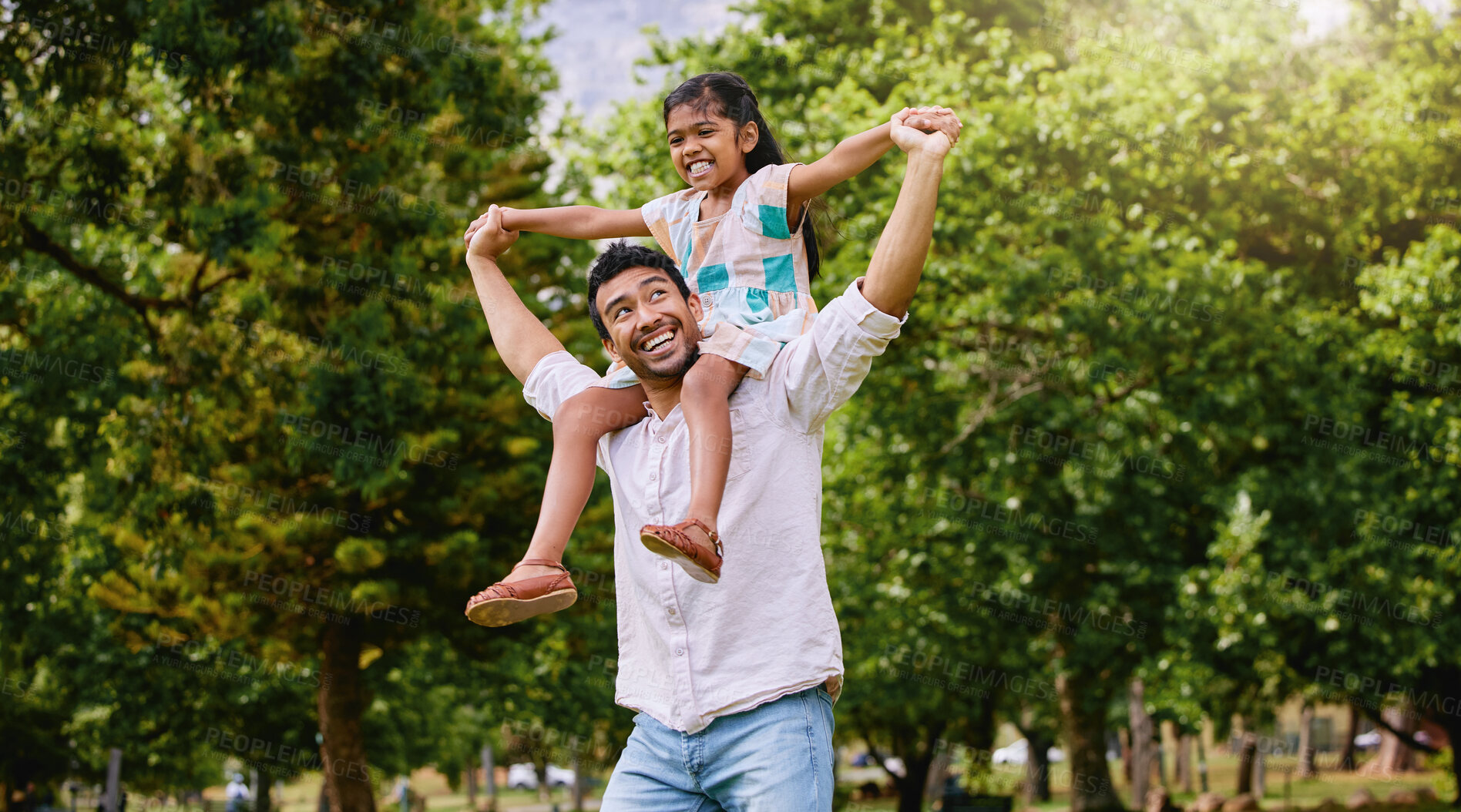 Buy stock photo Indian father, daughter and shoulders in park with smile, airplane game or piggyback in nature on holiday. Man, girl and playing together in garden, woods or summer sunshine for happy family vacation