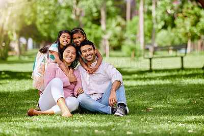 Buy stock photo Portrait, hug and asian family at a park happy, bonding and having fun outdoor together. Smile, love and children with parents on grass ground, embrace and relax while enjoying nature on the weekend
