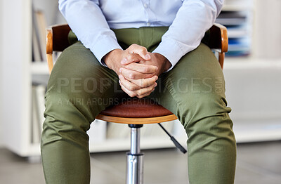Businessman with his hands clasped showing power and confidence. Unknown mixed race professional sitting alone in an office and patiently waiting. Anticipating corporate entrepreneur feeling ready