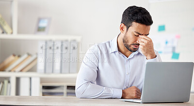 Buy stock photo Mental health, man with a headache and burnout with laptop at his desk at a modern workplace office. Stress or tired, mistake or fatigue problem and male person sad or depressed at his workstation