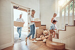 Happy caucasian parents with little kids moving into their new home. Excited couple carrying boxes up staircase with their son and daughter. Adorable children helping to unpack and move into property