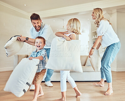Buy stock photo Pillow fight, happy parents and kids playing in living room with energy, funny game or joke together at home. Excited mom, dad and playful children with pillows, crazy morning and happiness of family