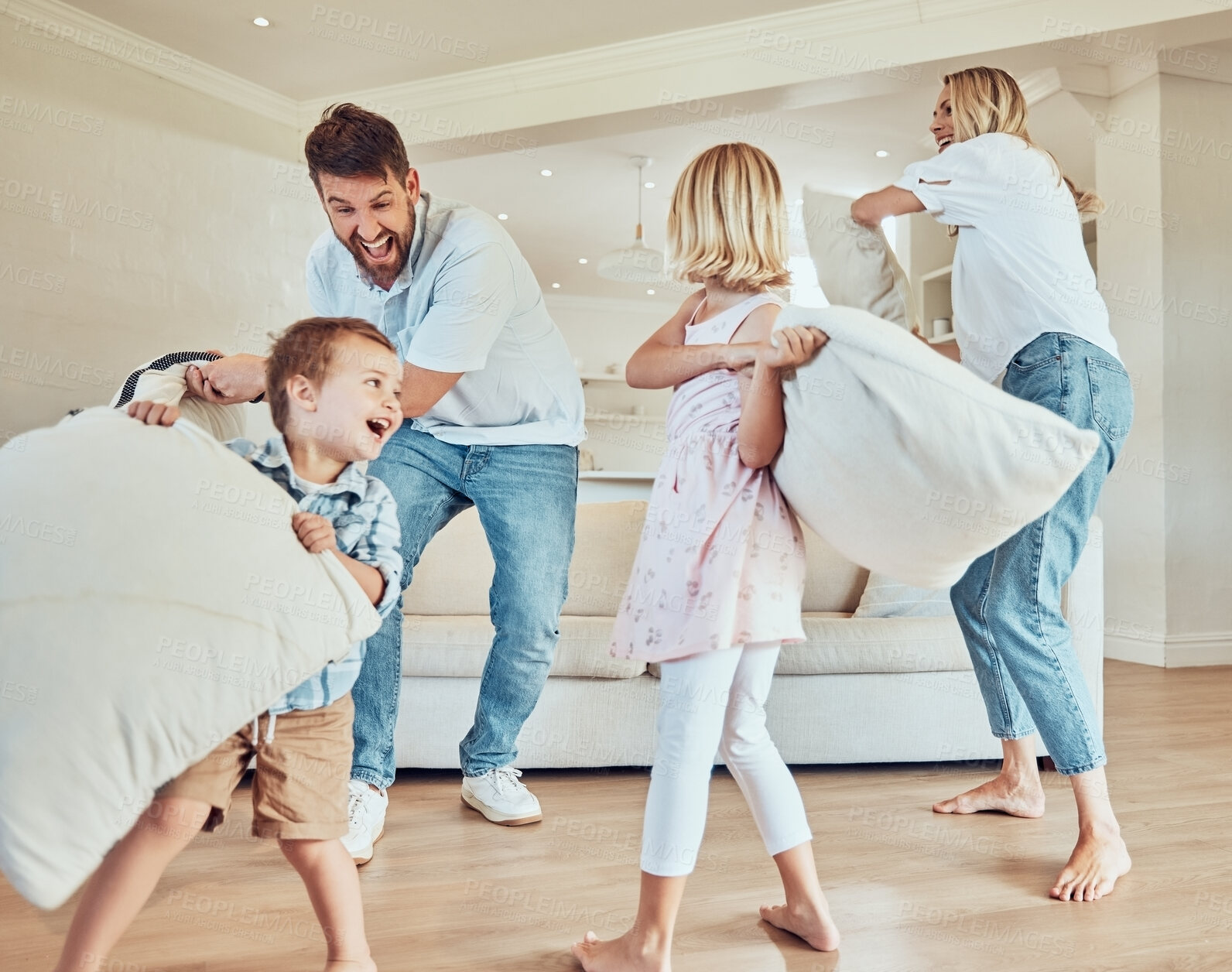Buy stock photo Pillow fight, playing and happy family of children in home laughing for funny games, joke and bond together in lounge. Excited mom, dad and playful kids with pillows for crazy energy in the morning