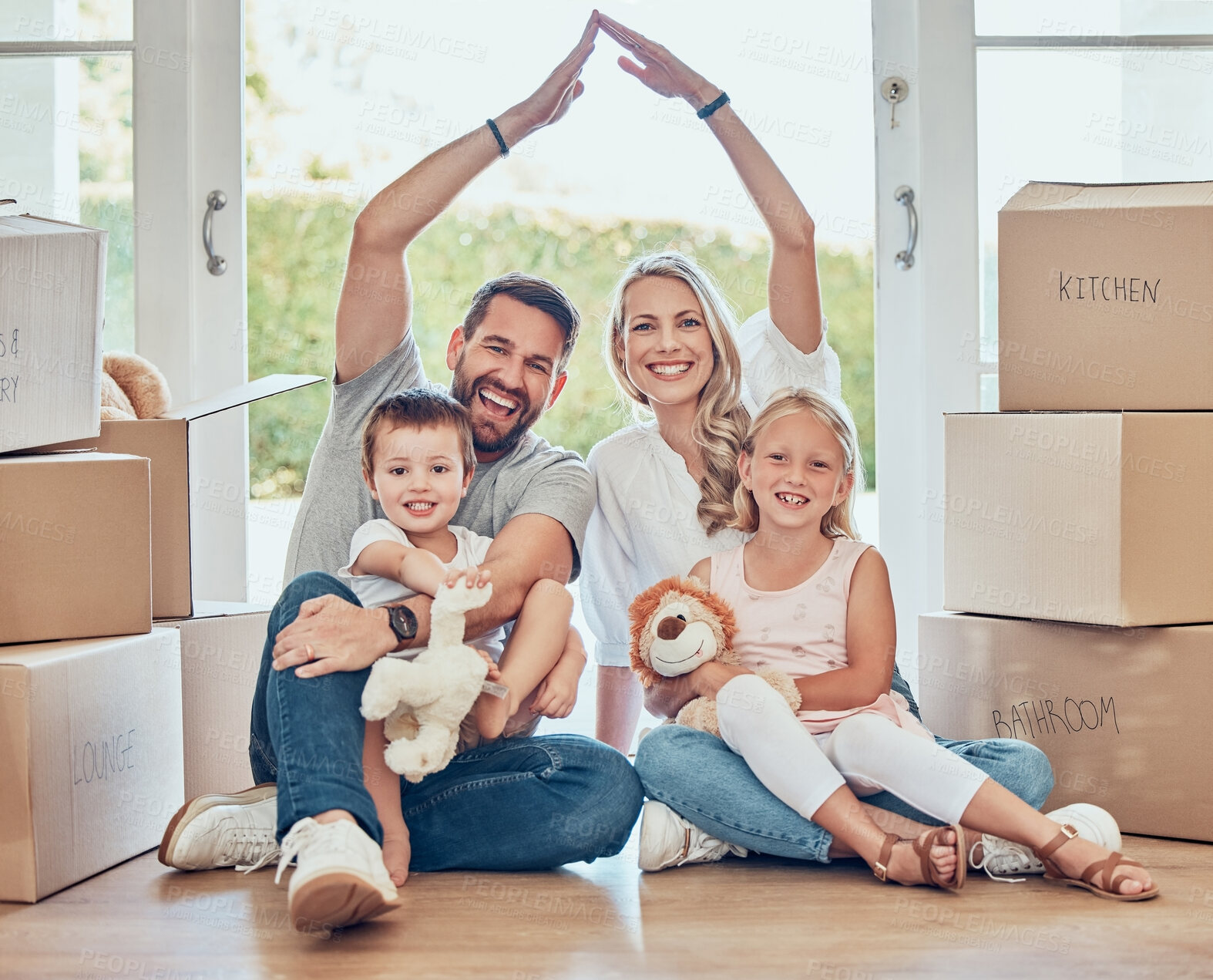 Buy stock photo Portrait of happy family, new home and roof for security, safety and future investment in real estate. Moving, boxes and happiness, mom and dad with kids in house with insurance for property mortgage