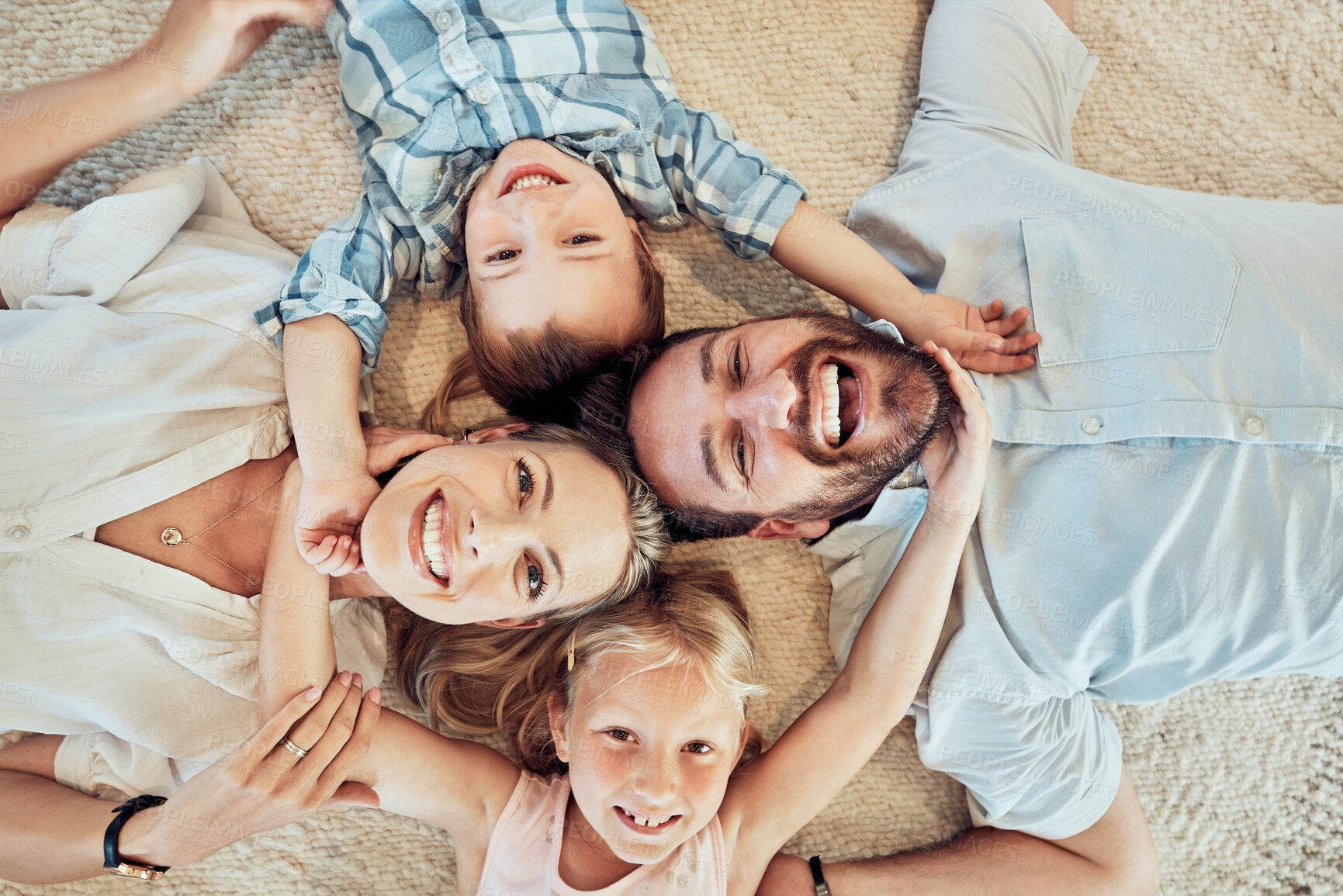 Buy stock photo Top view, happy family and portrait on bed for love, care and bonding for quality time together at home. Face of parents, kids and smile for happiness, break and relax in house for fun, joy and play
